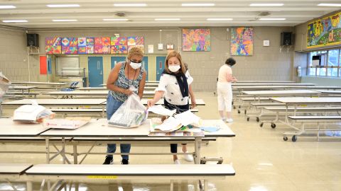 NEW YORK, NEW YORK - SEPTEMBER 08: (L-R) Assistant teachers Ayalibi Abreu and Segunda Garcia, and Principal Alice Hom prepare the school for the 2020/2021 school year at Yung Wing School P.S. 124  on September 08, 2020 in New York City. Most public school teachers and faculty returned today to prepare their classrooms for remote teaching as well as for students who will be coming in for in-person teaching. (Photo by Michael Loccisano/Getty Images)