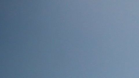 Una mujer pasando con una bicicleta frenta a un cartel de "playa cerrada" en South Beach, en Miami Beach.