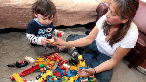 2/28/13--- LOS ANGELES----Child care provider Leticia Casillas plays with Elisha Rosado, 1, at her child care center in Los Angeles. (Photo by Aurelia Ventura/La Opinion)