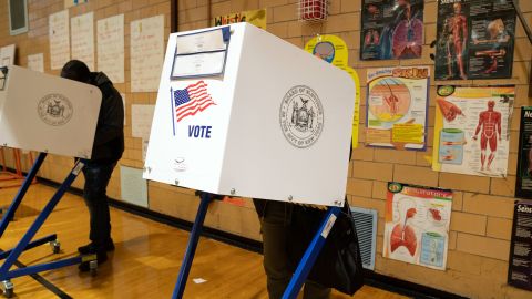 Medical diagrams hang on the wall of the gymnasium as people vote at Public School 33 in Chelsea on Election Day, November 3, 2020 in New York, City. - Americans were voting on Tuesday under the shadow of a surging coronavirus pandemic to decide whether to reelect Republican Donald Trump, one of the most polarizing presidents in US history, or send Democrat Joe Biden to the White House. (Photo by Bryan R. Smith / AFP) (Photo by BRYAN R. SMITH/AFP via Getty Images)