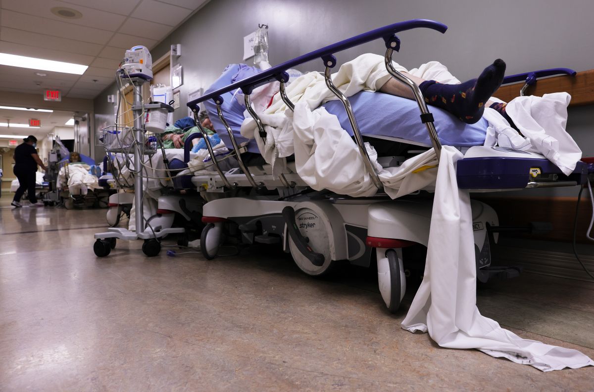 Pacientes con COVID-19 esperan atención en un pasillo de un hospital de California.