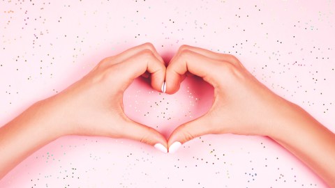 Beautiful,Young,Woman's,Hand,With,Perfect,Manicure,Making,Heart,On