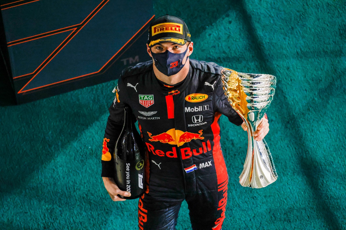 ABU DHABI, UNITED ARAB EMIRATES - DECEMBER 13: Race winner Max Verstappen of Netherlands and Red Bull Racing celebrates on the podium during the F1 Grand Prix of Abu Dhabi at Yas Marina Circuit on December 13, 2020 in Abu Dhabi, United Arab Emirates. (Photo by Peter Fox/Getty Images)