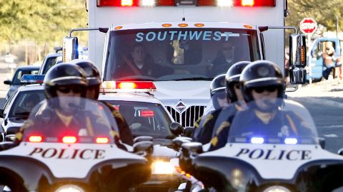 TUCSON, AZ - JANUARY 21: The ambulance carrying Rep. Gabrielle Giffords (D-AZ) leaves University Medical Center behind a police escort to move to Houston, Texas on January 21, 2011 in Tucson, Arizona. Giffords is being transferred from University Medical Center in Tucson to TIRR Memorial Hermann Rehabilitation Hospital in Houston to begin the next phase of her recovery from a gunshot wound.  (Photo by Greg Bryan-Pool/Getty Images)