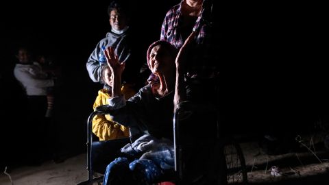 ROMA, TEXAS - APRIL 29: Honduran immigrant Trinidad Tabora, 93, raises her hands in prayer after crossing the border from Mexico on April 29, 2021 in Roma, Texas. She and her granddaughter (L) were smuggled across the Rio Grande with other Central American asylum seekers during the early hours of the morning. A surge of mostly Central American immigrants crossing into the United States has challenged U.S. immigration agencies along the U.S. southern border. (Photo by John Moore/Getty Images)