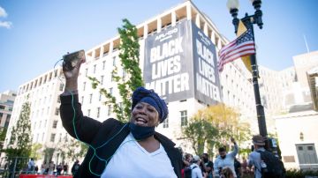 WASHINGTON, DC - APRIL 20: A person celebrates the verdict of the Derek Chauvin trial at Black Lives Matter Plaza near the White House on April 20, 2021 in Washington, D.C. Former police officer Derek Chauvin was on trial on second-degree murder, third-degree murder and second-degree manslaughter charges in the death of George Floyd May 25, 2020.  After video was released of then-officer Chauvin kneeling on Floyd’s neck for nine minutes and twenty-nine seconds, protests broke out across the U.S. and around the world. The jury found Chauvin guilty on all three charges. (Photo by Sarah Silbiger/Getty Images)