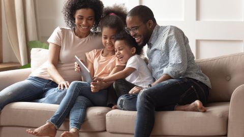 Happy,African,Family,Having,Fun,With,Device,At,Home,,Black