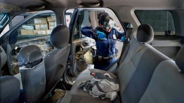 An Immigration and Customs Enforcement (ICE) agent searches an automobile for contraband in the line to enter the United States at the San Ysidro Port of Entry on October 2, 2019 in San Ysidro, California. - Fentanyl, a powerful painkiller approved by the US Food and Drug Administration for a range of conditions, has been central to the American opioid crisis which began in the late 1990s. China was the first country to manufacture illegal fentanyl for the US market, but the problem surged when trafficking through Mexico began around 2005, according to Donovan. (Photo by SANDY HUFFAKER / AFP) (Photo by SANDY HUFFAKER/AFP via Getty Images)