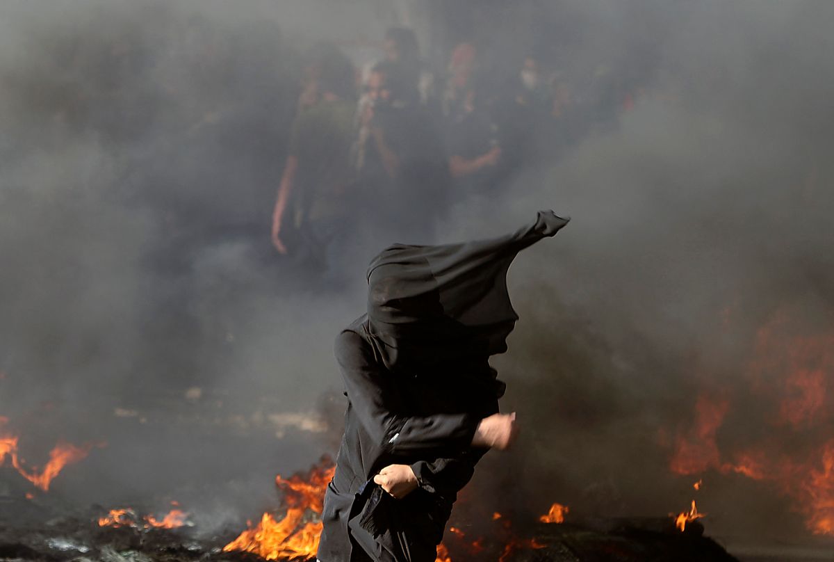 Una manifestante de Palestina se enfrenta a tropas israelíes en un puesto de inspección en Hawara, en la zona ocupada de West Bank.  