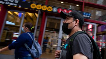 A man wears a face masks in Midtown Manhattan in New York on July 29 2021. - Every US federal worker must either declare they are fully vaccinated against Covid-19 or wear masks and be regularly tested, President Joe Biden was to announce July 29, 2021, the White House said, as his administration beefs up actions against the surging delta variant. The governors of New York and New Jersey on July 28, 2021 publicly backed the idea of indoor masking for vaccinated people in high Covid-19 risk areas. (Photo by Kena Betancur / AFP) (Photo by KENA BETANCUR/AFP via Getty Images)