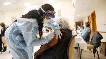 TAMPA, FL - JANUARY 10: A healthcare worker administers the COVID-19 vaccine to residents living in the Jackson Heights neighborhood at St. Johns Missionary Baptist Church on January 10, 2021 in Tampa, Florida. The Florida Department of Health is targeting the underserved populations that are most vulnerable to getting the coronavirus, specifically the African and Latin American communities. (Photo by Octavio Jones/Getty Images)