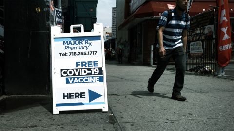 NEW YORK, NEW YORK - JUNE 04: People walk by a Covid-19 vaccine site in the Queens borough of New York City on June 04, 2021 in New York City. The U.S. economy added 559,000 jobs in May, bringing the unemployment rate down to 5.8 percent from 6.1 percent. Despite the positive economic news, millions of Americans are still looking for work or are in need of financial, food, and housing assistance. (Photo by Spencer Platt/Getty Images)