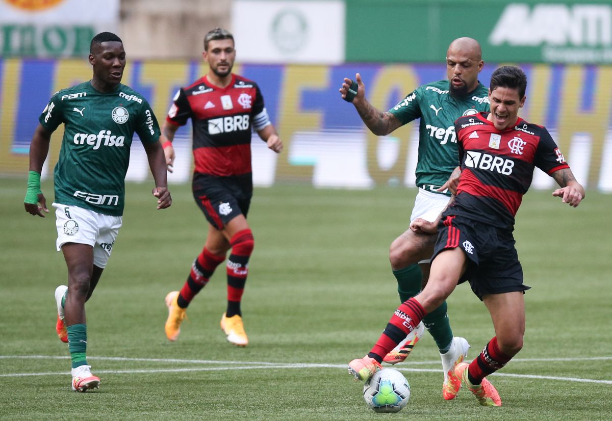 Felipe Melo de Palmeiras y Lincoln de Flamengo luchan por el balón durante un partido del torneo Brasileirao.