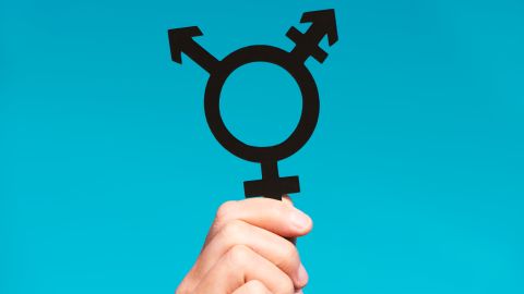Closeup,Of,A,Young,Caucasian,Person,Holding,A,Transgender,Symbol