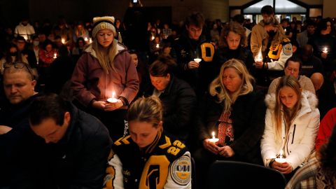 Oxford High students stand holding candles during a vigil after a shooting at Oxford High School at Lake Pointe Community Church in Lake Orion, Michigan on November 30, 2021. - A 15-year-old student opened fire at his Michigan high school on November 30, killing three teenagers and wounding eight other people before surrendering to police, authorities said, in what was the deadliest US school shooting so far this year. (Photo by JEFF KOWALSKY / AFP) (Photo by JEFF KOWALSKY/AFP via Getty Images)