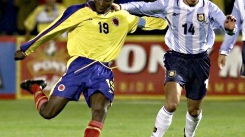 Freddy Rincon (L) of Colombia kicks the ball in fr