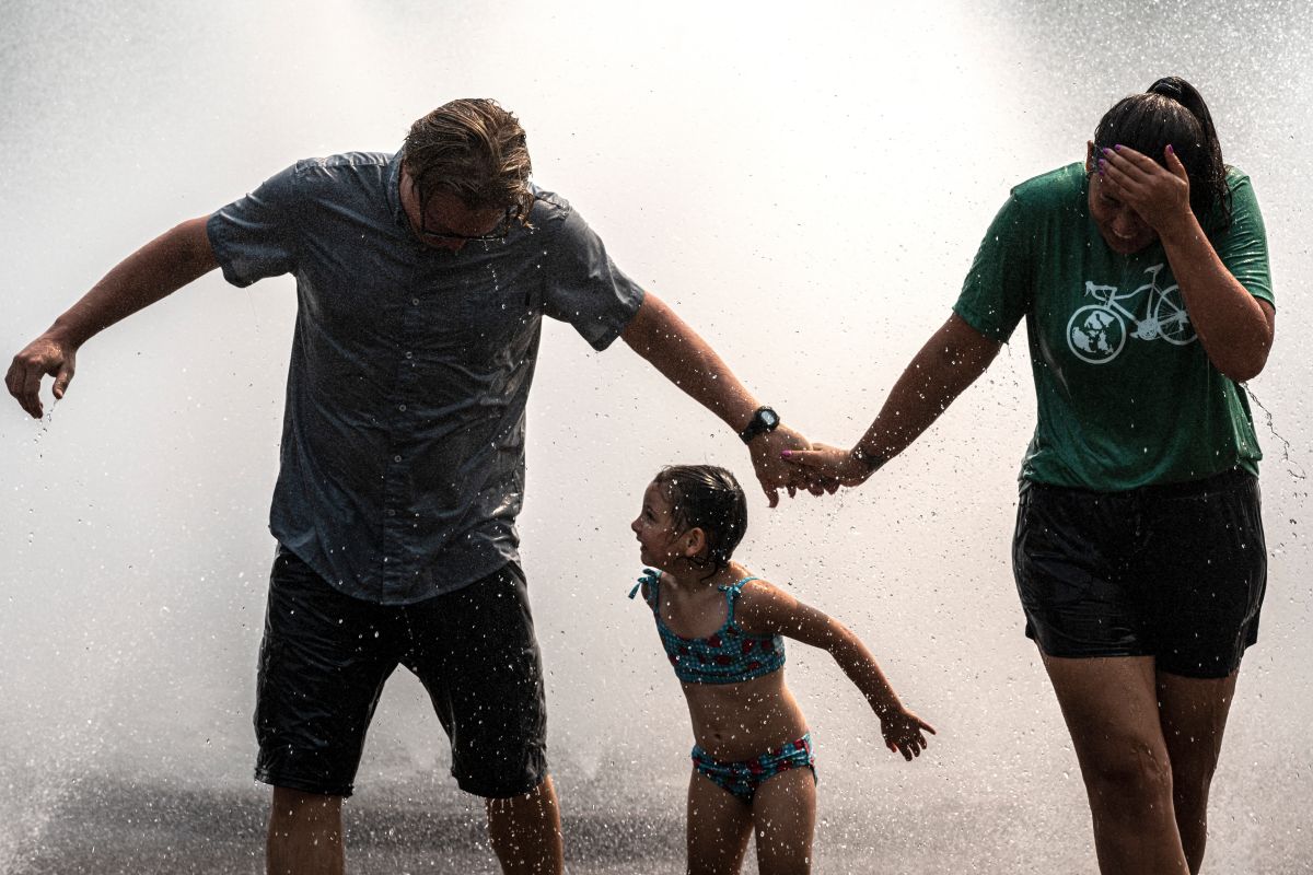 Una familia se divierte a pesar del calor en "Salmon Springs Fountain", en Portland, Oregon.