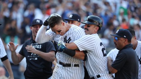 Aaron Judge (C) es recibido por sus compañeros tras conectar su jonrón 28 y decretar la victoria para Yankees ante Astros.