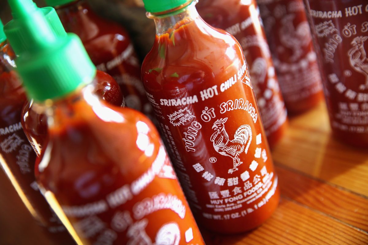 CHICAGO, IL - DECEMBER 12:  Bottles of Sriracha hot chili sauce are shown on December 12, 2013 in Chicago, Illinois. Huy Fong Foods, the maker of Sriracha, says it can't ship any more of its sauce until next month because in California, where the sauce is produced, the Department of Public Health is now enforcing stricter guidelines that require sauces be held for 35 days before they are shipped. (Photo Illustration by Scott Olson/Getty Images)