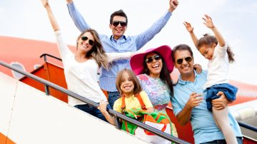 Excited,Family,With,Arms,Up,Traveling,By,Airplane
