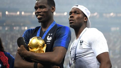 Paul Pogba (L) y Mathias Pogba (R) posan junto a la Copa del Mundo luego que Francia derrotara 4-2 a Croacia en la final del Mundial de Rusia 2018.