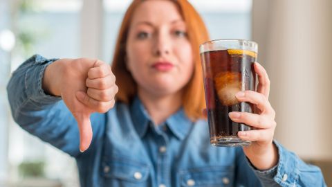 Redhead,Woman,Holding,Soda,Refreshment,With,Angry,Face,,Negative,Sign