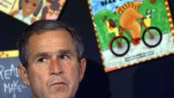 US President George W. Bush reacts after