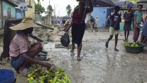 people walk to an open market in the rai