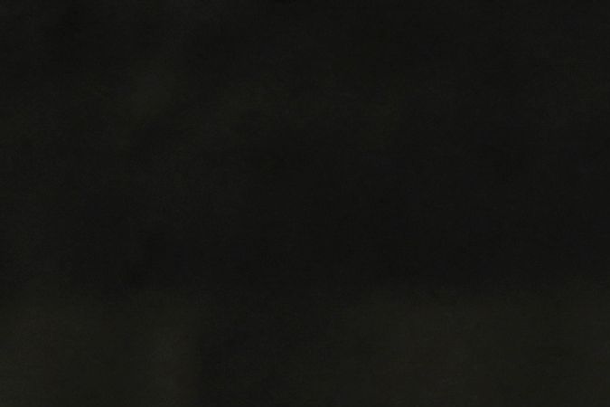 A man with his bicycle passes in front of damaged cars from a vehicle assembly company after a landslide during heavy rains in Las Tejerias, Aragua state, Venezuela, on October 10, 2022. - A landslide in central Venezuela left at least 22 people dead and more than 50 missing after heavy rains caused a river to overflow, Vice President Delcy Rodriguez said Sunday. (Photo by Yuri CORTEZ / AFP) (Photo by YURI CORTEZ/AFP via Getty Images)