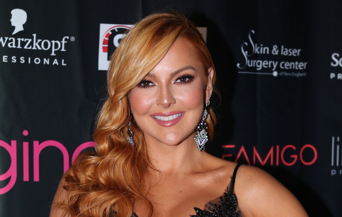 Marjorie de Sousa wears a top that shows off her voluptuous breasts and toned abdomen