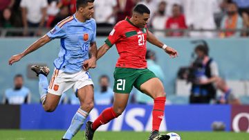 Walid Cheddira (R) disputa un balón con Rodri (L) en el encuentro entre Marruecos y España en Qatar 2022.