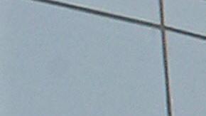 A US and a Chinese flag wave outside a c