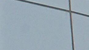 A US and a Chinese flag wave outside a c