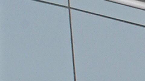 A US and a Chinese flag wave outside a c