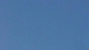 An Iranian flag flutters next to a groun