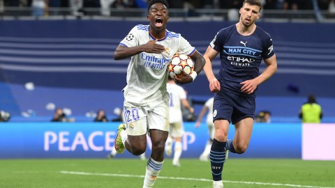 Vinicius Jr. (I) del Real Madrid junto a Ruben Dias (D) del Manchester City en un juego de Champions.