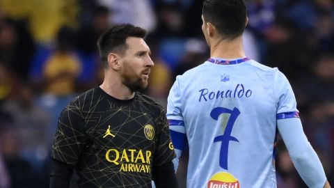 TOPSHOT - Paris Saint-Germain's Argentine forward Lionel Messi (L) walks past Riyadh All-Star's Portuguese forward Cristiano Ronaldo (R) during the Riyadh Season Cup football match between the Riyadh All-Stars and Paris Saint-Germain at the King Fahd Stadium in Riyadh on January 19, 2023. (Photo by FRANCK FIFE / AFP) (Photo by FRANCK FIFE/AFP via Getty Images)