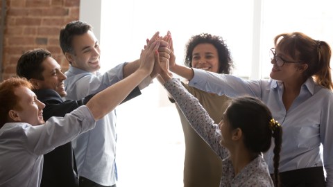 Overjoyed,Multi,Racial,Businesspeople,Succeed,Goal,Giving,High,Five,Feels
