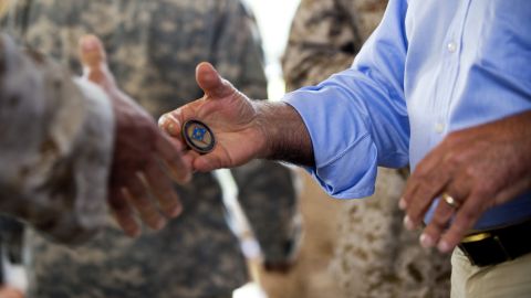 HONOLULU, HI - MAY 31: U.S. Secretary of Defense Leon Panetta hands out coins after speaking with troops at US Pacific Command on May 31, 2012 in Honolulu, Hawaii. Panette's visit with troops will be followed by the annual Asian security summit and a two day visit to Vietnam and India. (Photo by Jim Watson-Pool/Getty Images)