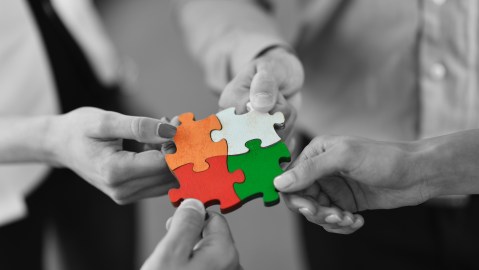 Group,Of,Business,People,Assembling,Jigsaw,Puzzle,And,Represent,Team