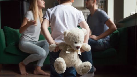 Rear,View,At,Kid,Boy,Holding,Toy,While,Parents,Fighting,