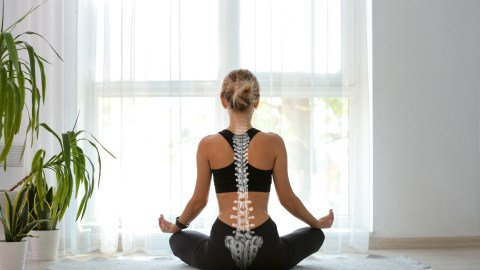 Young,Woman,With,Good,Posture,Meditating,At,Home,,Back,View
