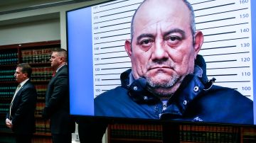 TOPSHOT - A picture of Colombian drug lord Dairo Antonio Usuga, aka Otoniel, is displayed on a screedn as Eastern District of New York Attorney Breon Peace (out of frame) speaks during a press conference about his extradition in New York City on May 5, 2022. - One of Colombia's most notorious drug lords was extradited Wednesday to the United States to face drug trafficking charges, announced President Ivan Duque. "I want to reveal that Dairo Antonio Usuga, alias 'Otoniel' has been extradited," Duque said on Twitter, calling him "the most dangerous drug trafficker in the world." (Photo by Kena Betancur / AFP) (Photo by KENA BETANCUR/AFP via Getty Images)