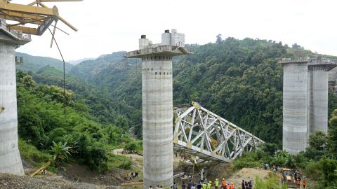 TOPSHOT - Rescue workers conduct a search operation at the site of an accident where an under-construction railway bridge collapsed in Sairang town of the Aizwal district in India's eastern state of Mizoram on August 23, 2023. At least 17 labourers working on a railway bridge being built across a ravine in India's eastern Mizoram state were killed when it collapsed on August 23, officials said, with others reported missing. (Photo by AFP) (Photo by -/AFP via Getty Images)