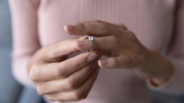 Close,Up,Young,Woman,Taking,Off,Wedding,Ring,,Divorce,Concept,