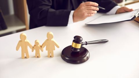 Close,Up,Of,Wooden,Family,Figurines,And,Gavel,On,The