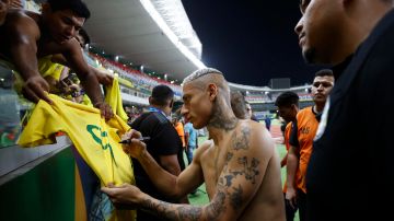 Richarlison firma la camiseta de un hincha al final del partido entre Brasil y Bolivia de las Eliminatorias Sudamericanas.
