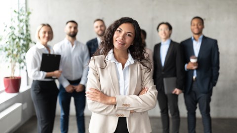Successful,Business,Team.,Mexican,Businesswoman,Standing,In,Front,Of,Her