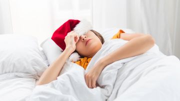 Woman,In,Santa,Claus,Hat,Sleeps,In,Bed.,Morning,After