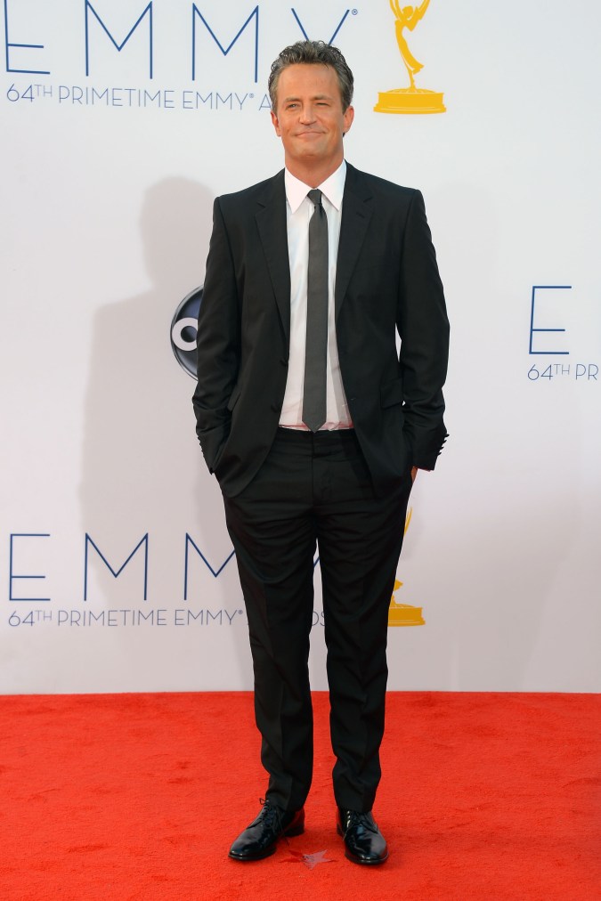 Matthew Perry posando en una alfombra roja.